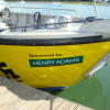 sponsored by green decal on a yellow boat